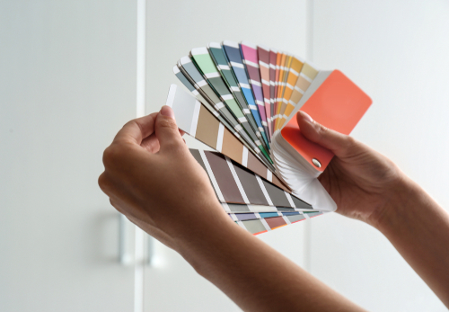 A person looking at paint swatches